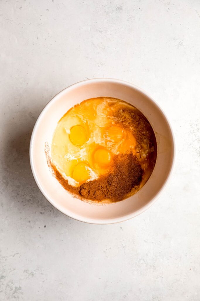 A mixing bowl of the wet ingredients for eggnog French toast.