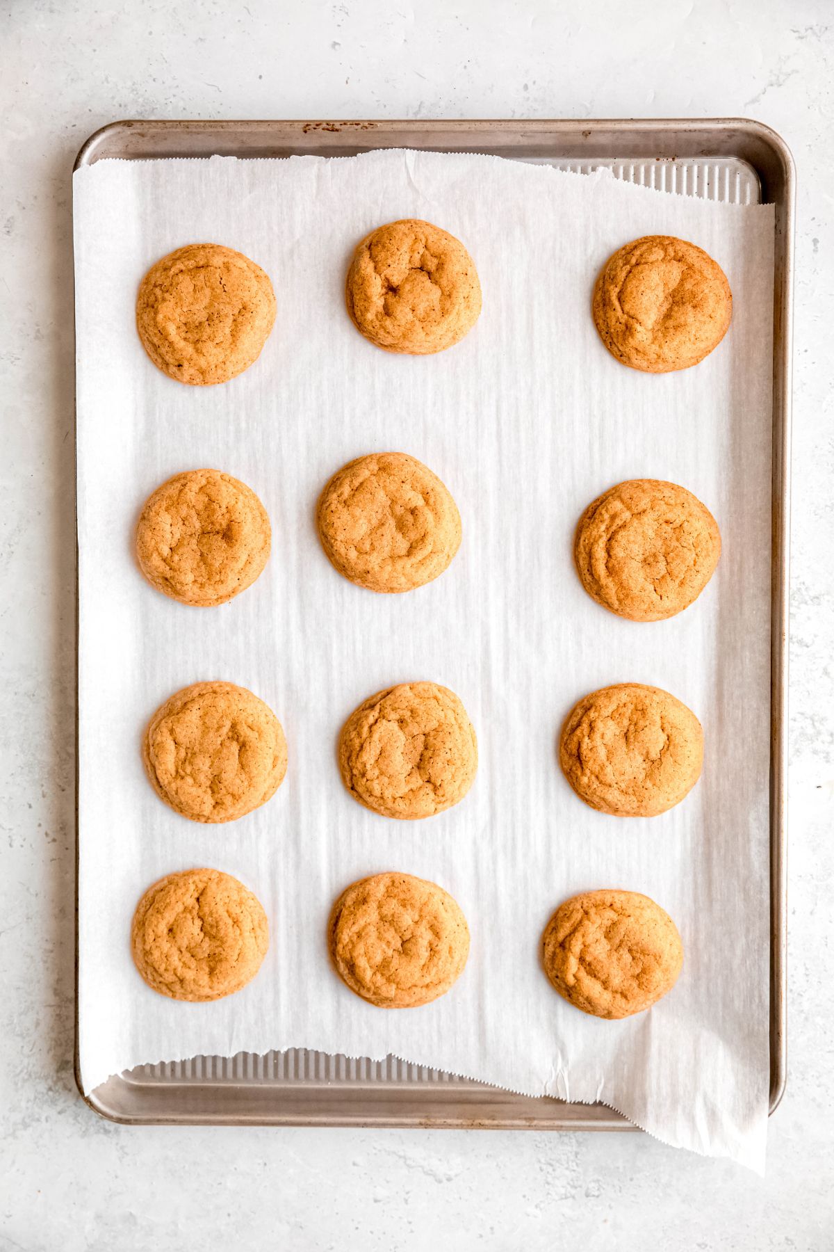 eggnog snickerdoodles on a baking sheet after baking.
