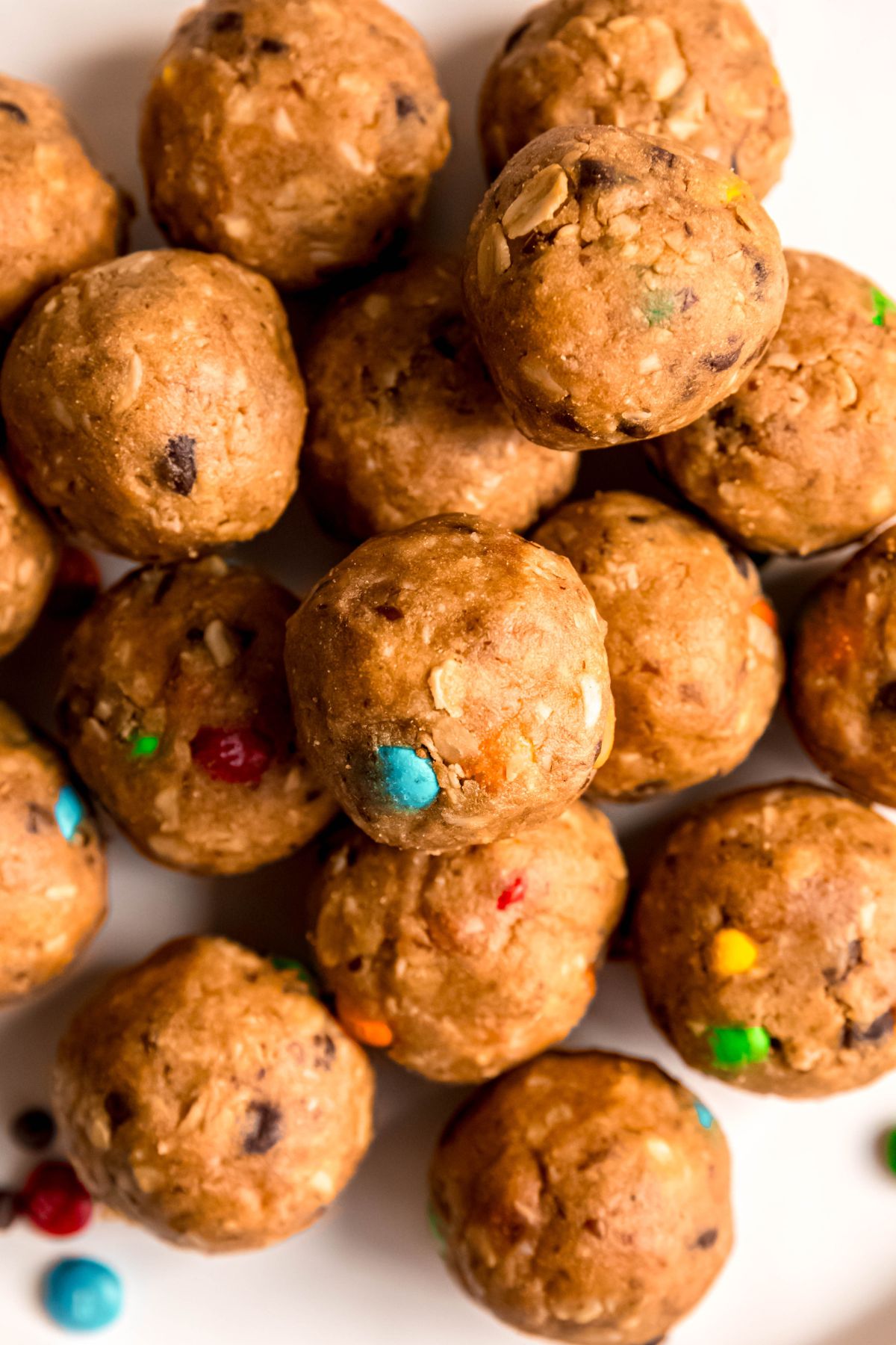 closeup overhead shot of a pile of monster cookie energy bites showing their texture from the oats and mix ins.