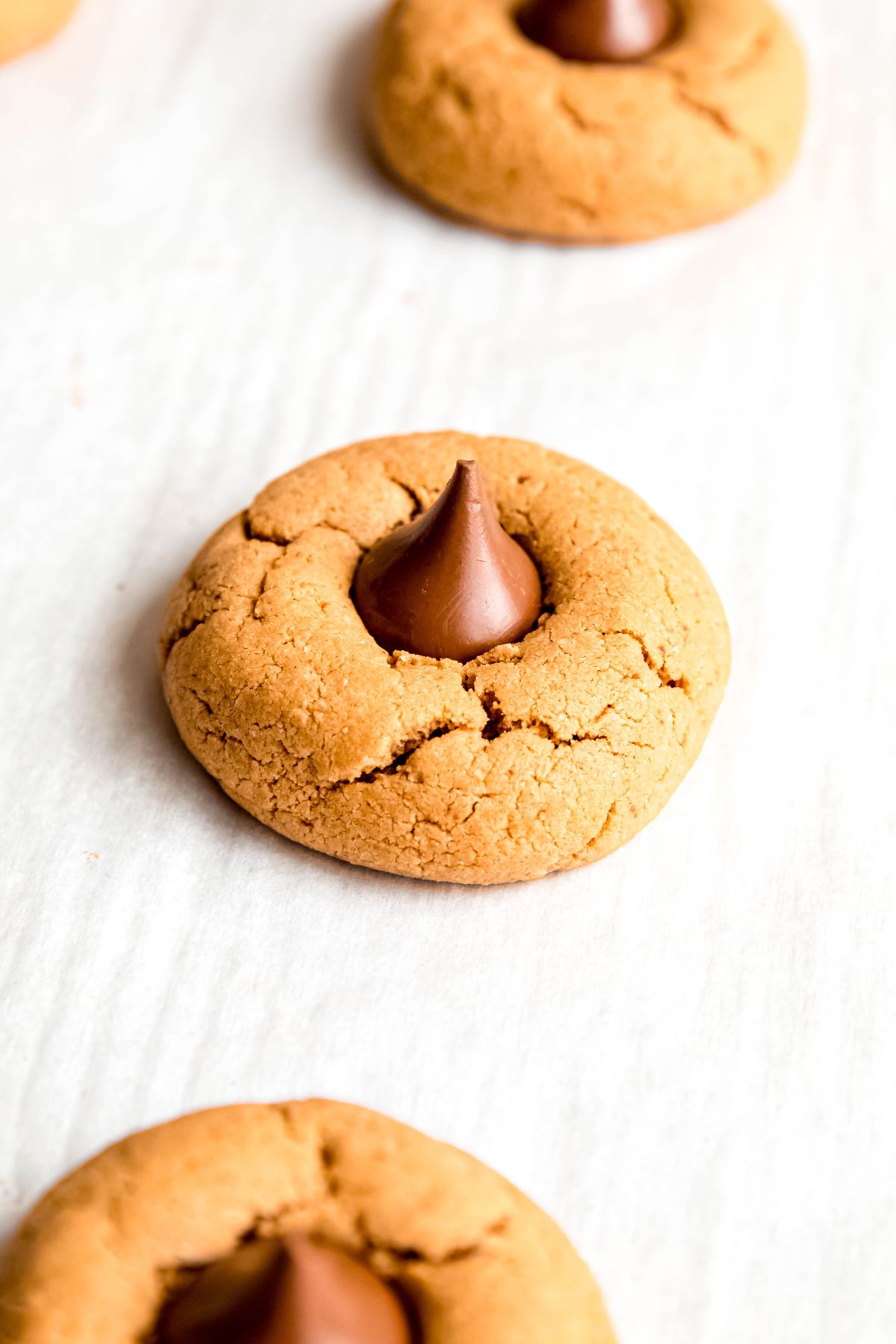 An elevated shot of a high protein butter protein cookie on a piece of parchment paper.