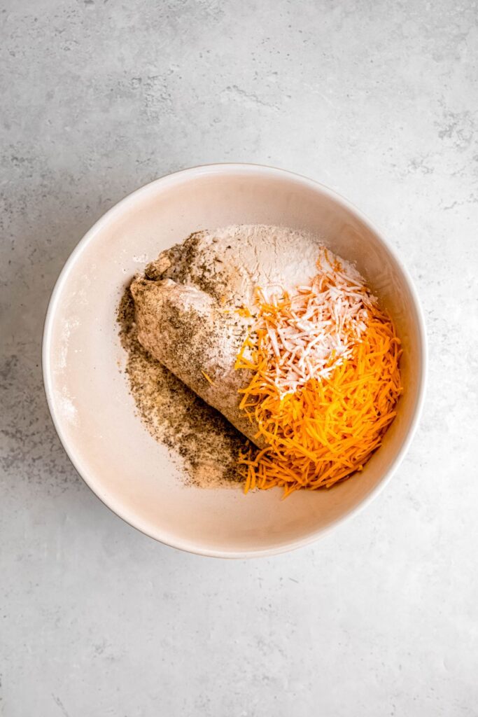 all sausage cheese ball ingredients added to a mixing bowl.