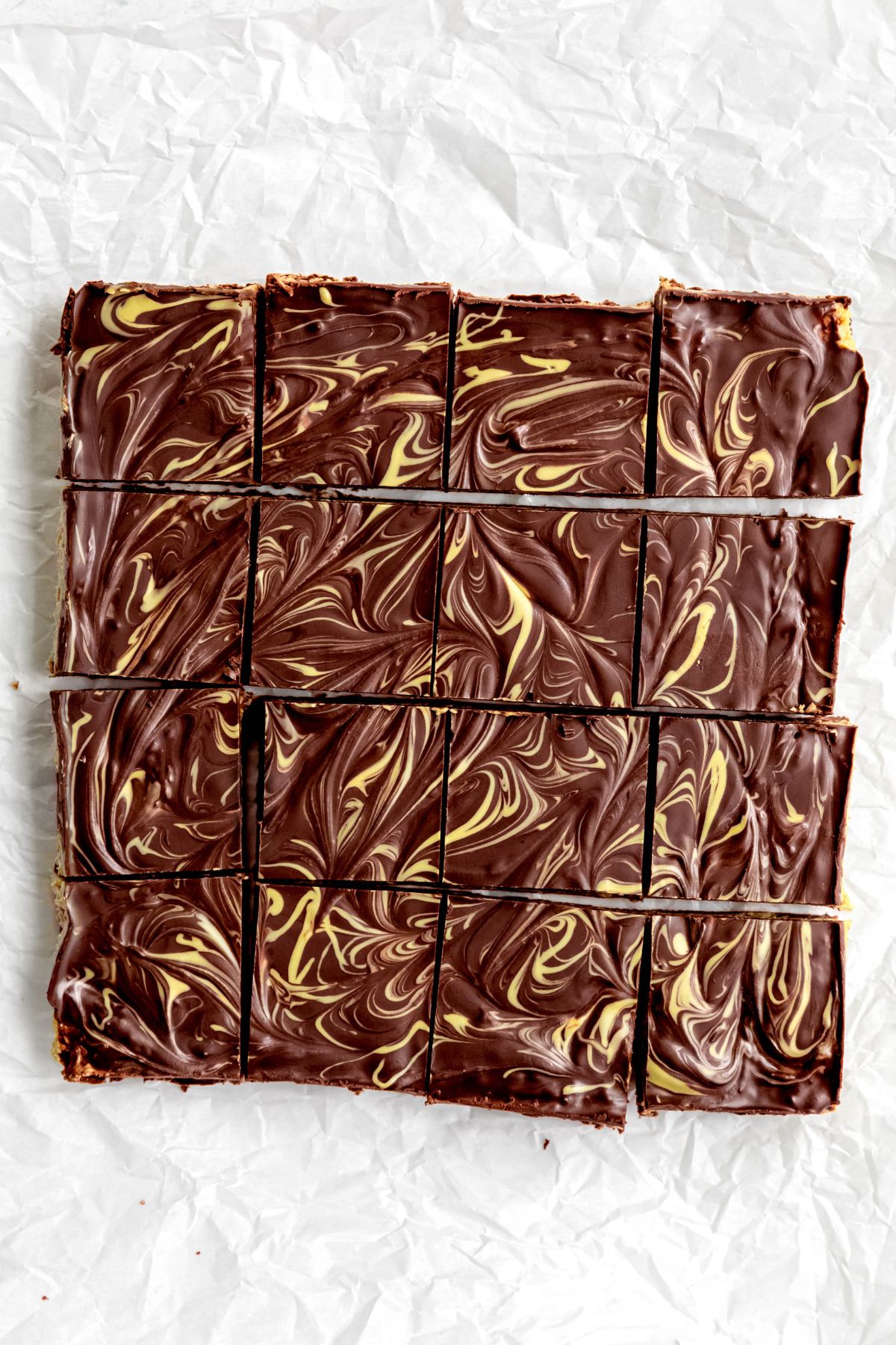 tray of dubai chocolate pistachio brownies after slicing into 16 squares.