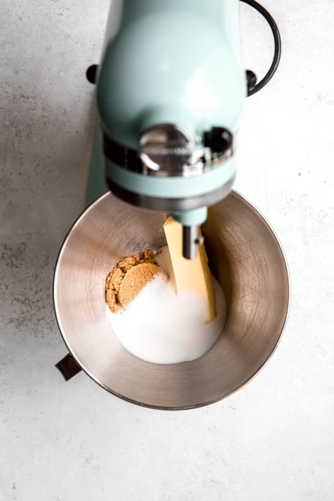 butter and sugars added to a stand mixer bowl.