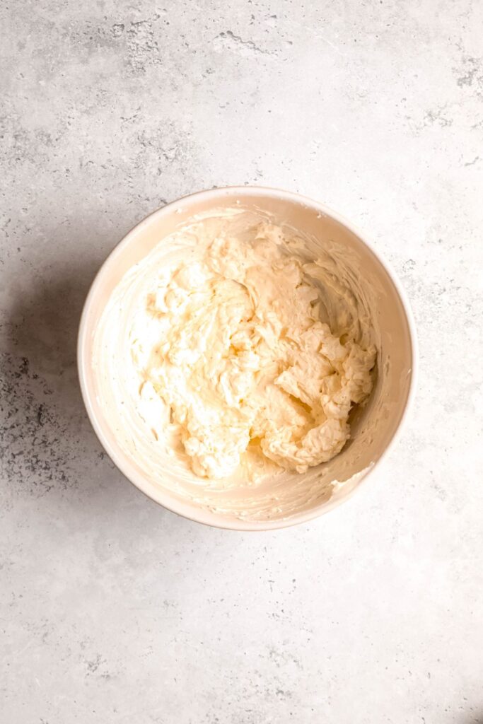 cream cheese and greek yogurt mixture in a bowl after mixing.