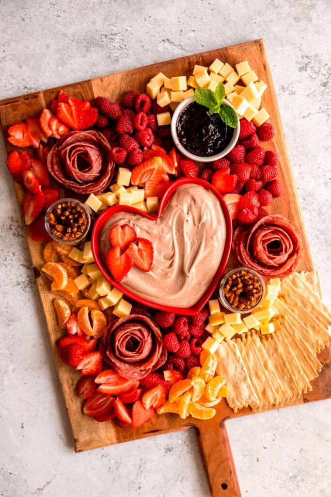The completed board, with cubed cheese, strawberries, oranges, and more.