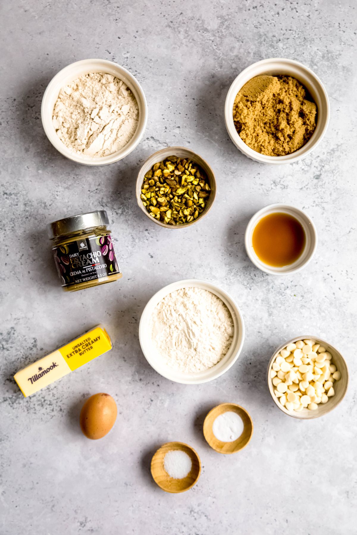 ingredients needed to make stuffed pistachio cookies recipe measured out on a grey table.