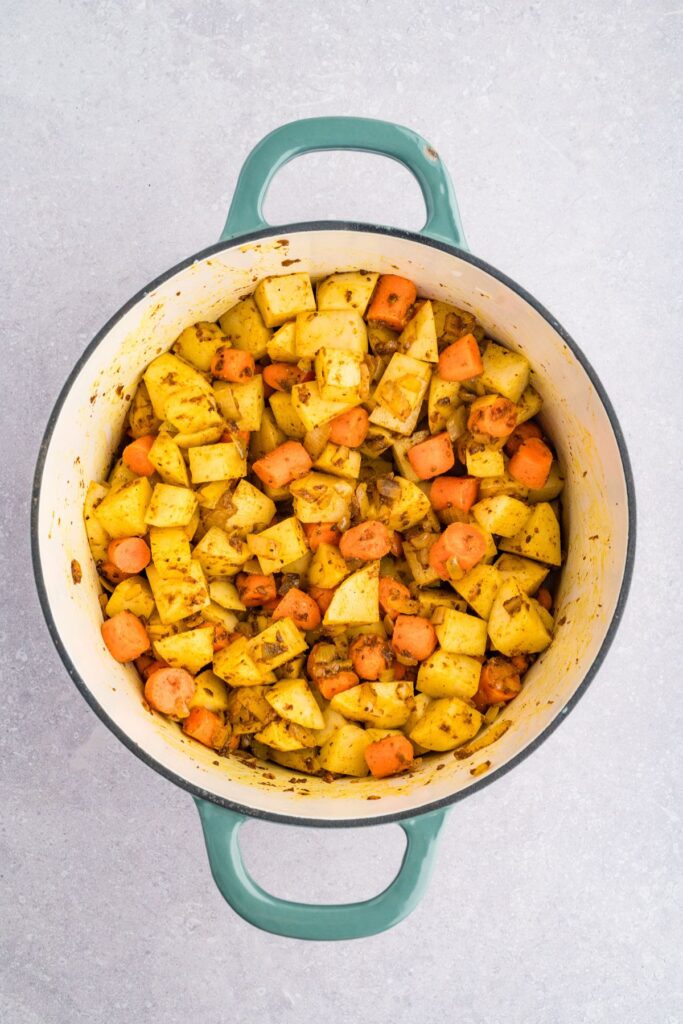 potatoes and carrots added to the spiced onion mixture.