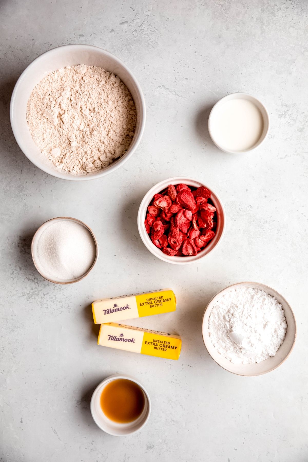 ingredients needed to make strawberry shortbread cookies recipe measured out on a white table.