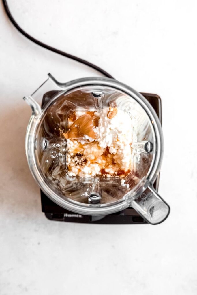 wet cottage cheese cookie dough ingredients added to a blender.
