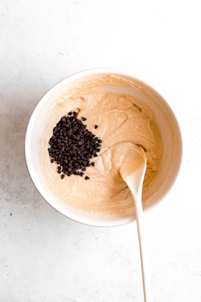 mini chocolate chips added to the bowl with the edible protein cookie dough.