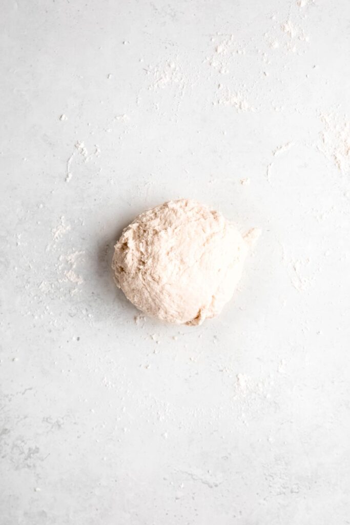flatbread dough turned out onto a lightly floured surface for kneading.