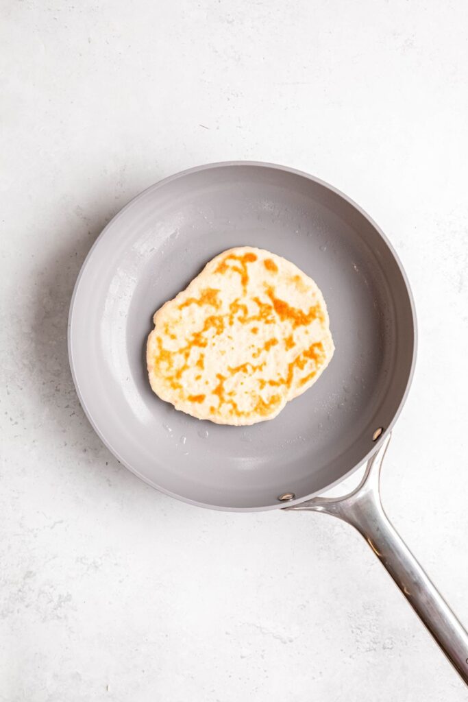 cottage cheese flatbread cooking in a nonstick skillet.