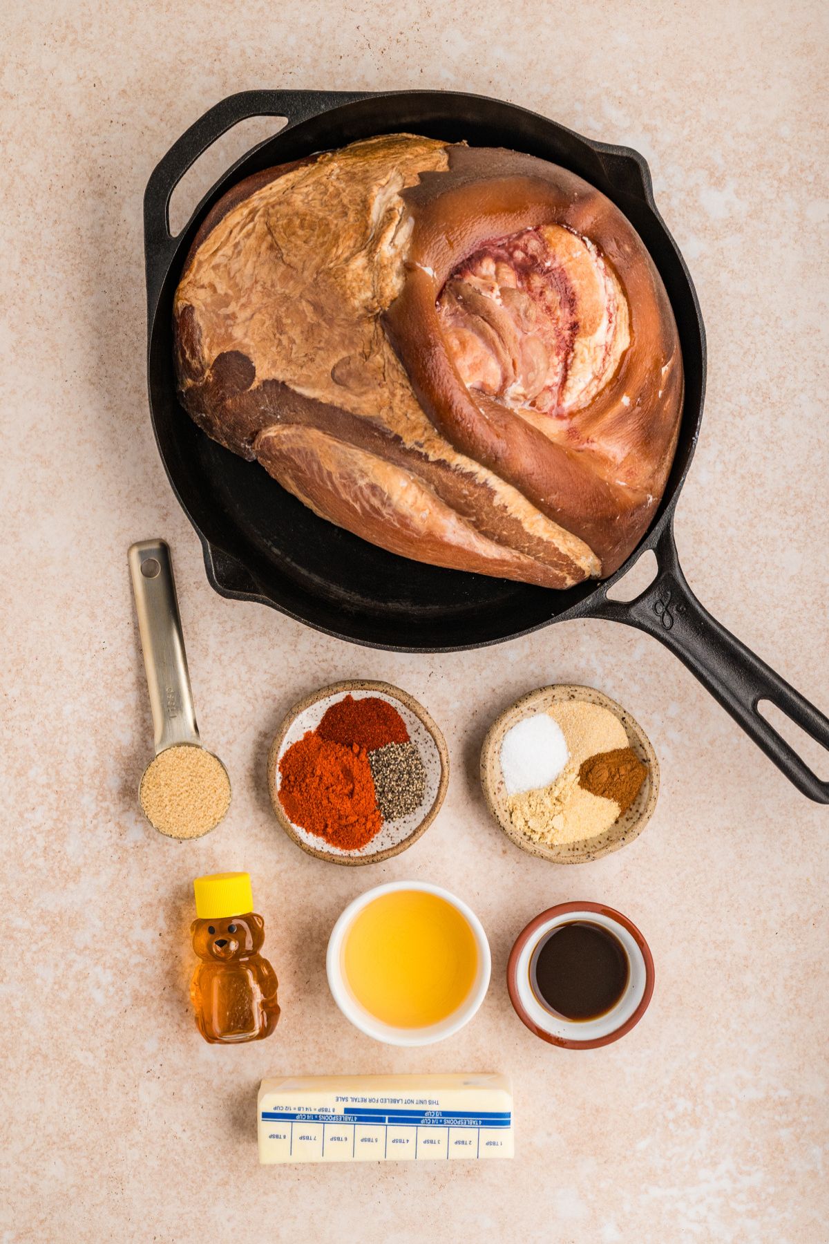 ingredients needed for making glazed double smoked ham recipe measured out on a beige table.