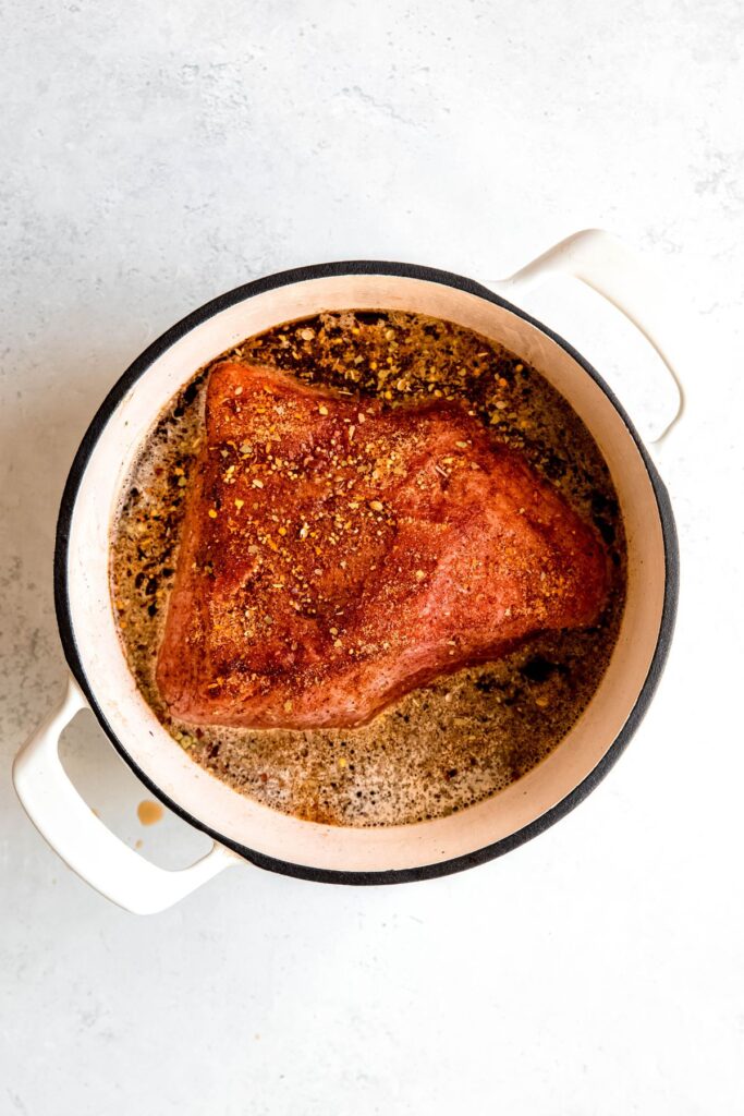 The browned corned beef in the Dutch oven.