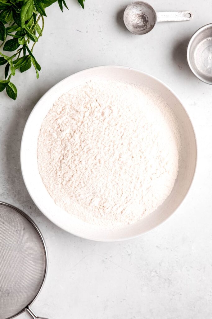 completed self-rising flour in a white bowl after sifting.