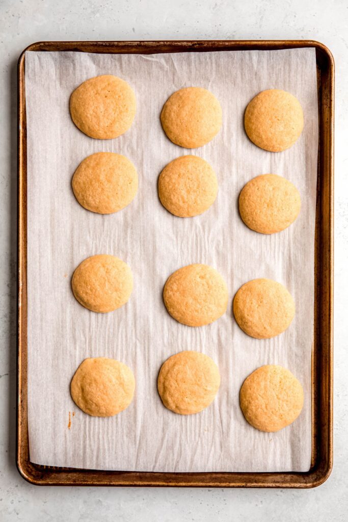 baked lemon ricotta cookies on the baking sheet.