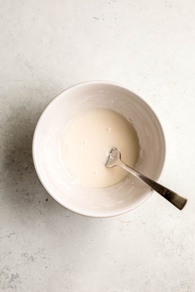 simple lemon powdered sugar glaze in a white bowl.