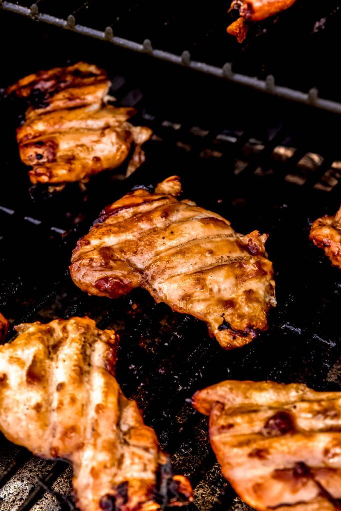 marinated teriyaki chicken thighs on the grill.