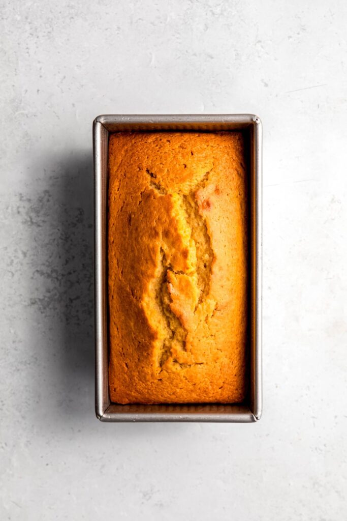 baked lemon loaf cake in the pan before adding the lemon glaze.
