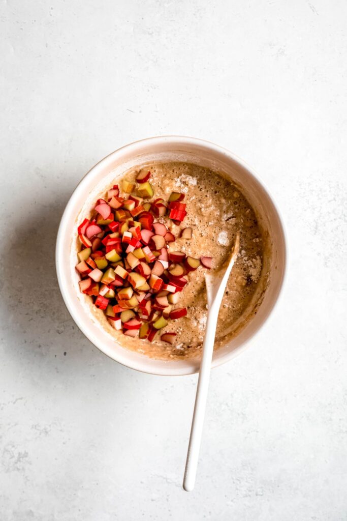 quick bread batter with fresh rhubarb chunks added to the bowl.