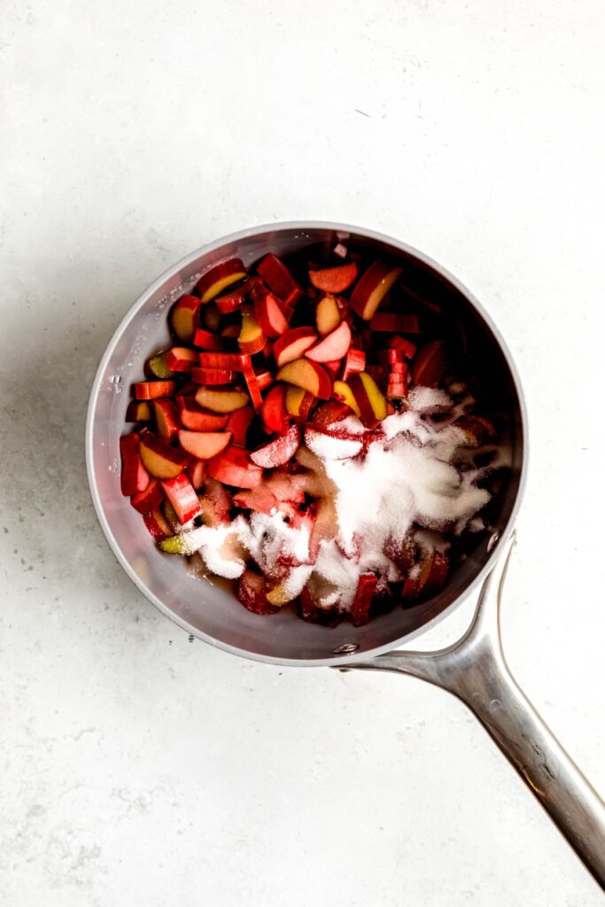 sliced rhubarb, sugar, oj, and water added to a saucepan.
