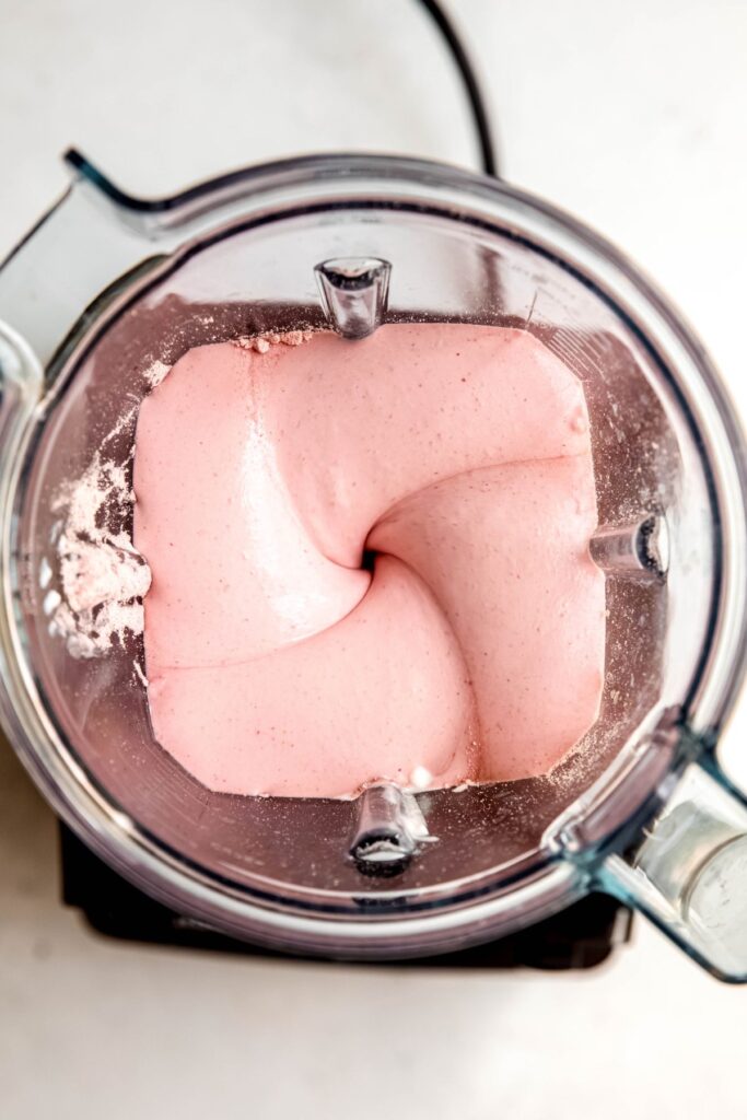 strawberry cottage cheese mixture blending in the base of a vitamix.